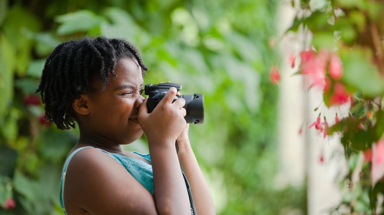 Child holding a camera to take a photo